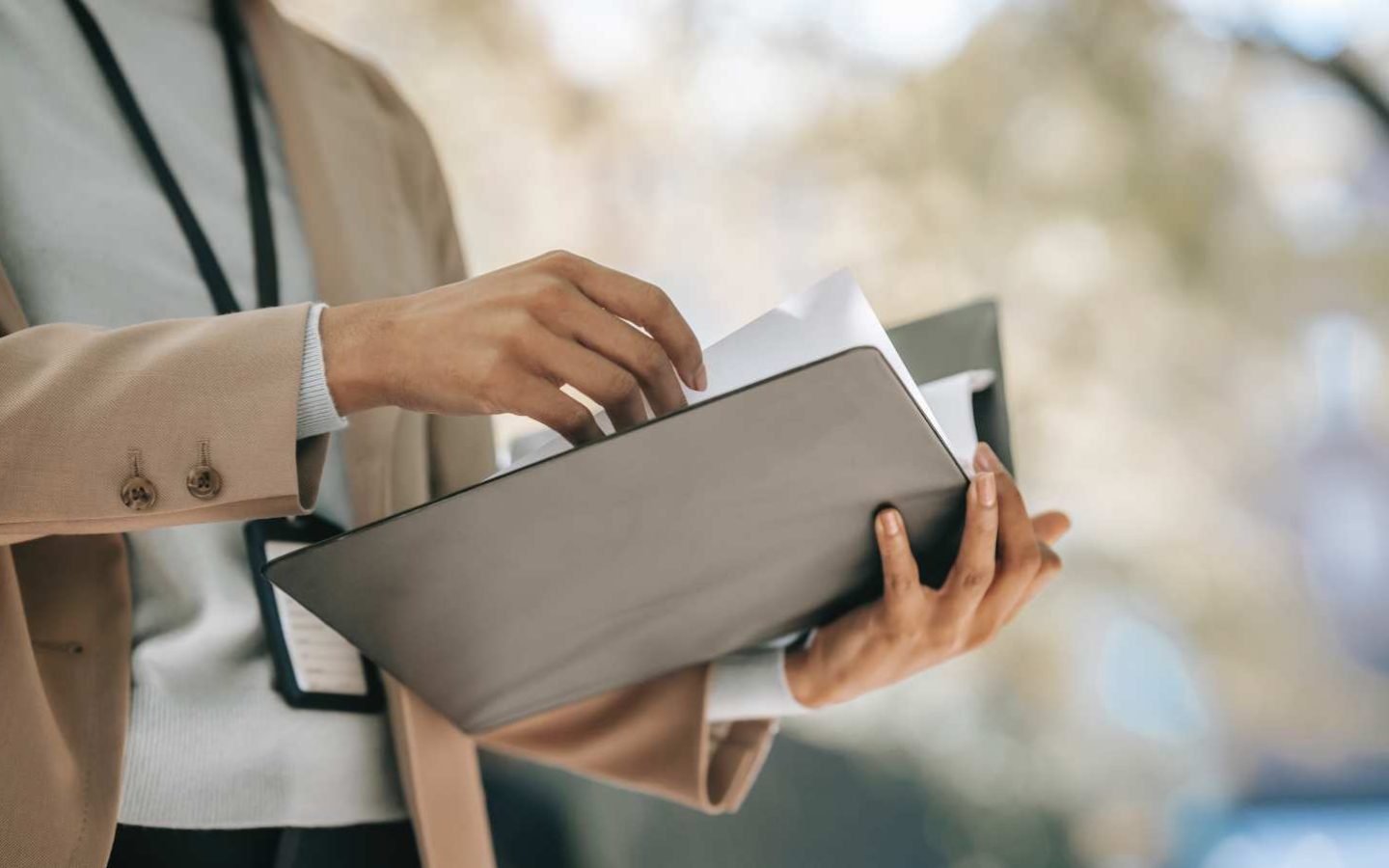 person looking through a document in a folder